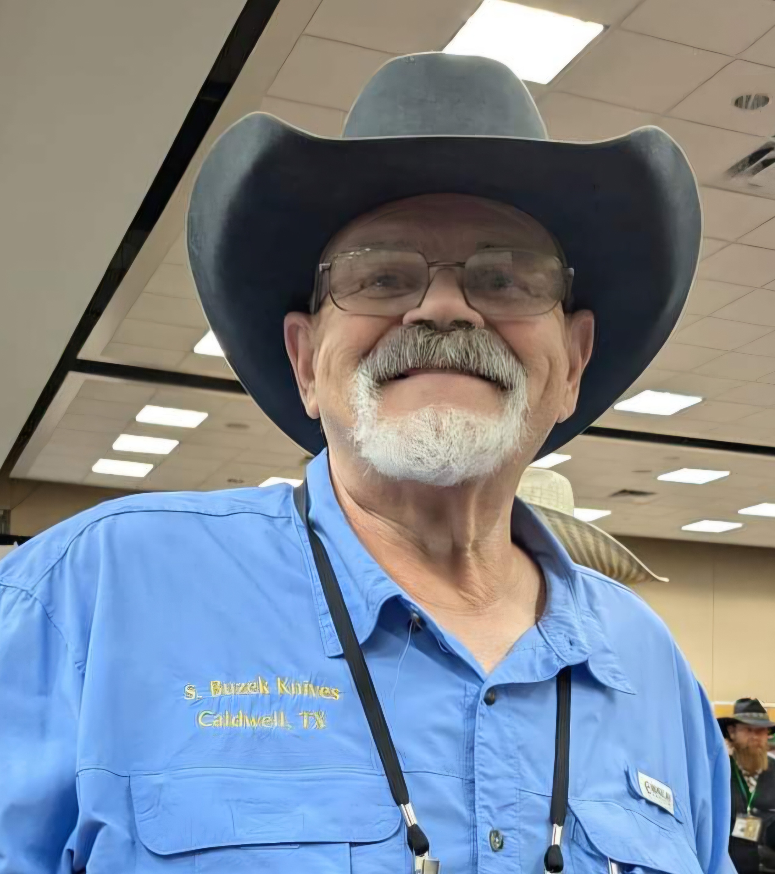Stanley Buzek wearing a cowboy hat and blue shirt
